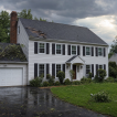 Storm damage roof repair in Fairfax VA - colonial home with damaged shingles after a thunderstorm
